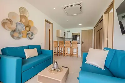 a living room with a blue couch and a table at Vista a Laguna cristalina + 2 alc + parking in Cartagena de Indias