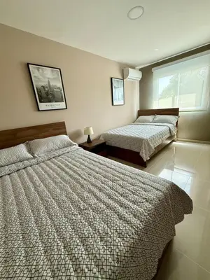 a bedroom with two beds and a window at Apto Moderno Cómodo y acogedor Excelente ubicación Norte Barranquilla in Barranquilla