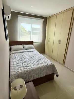 a small bedroom with a bed and a window at Apto Moderno Cómodo y acogedor Excelente ubicación Norte Barranquilla in Barranquilla