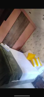 a bed with two pillows on top of it at Barranquilla Dreams in Puerto Colombia