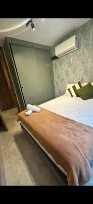 a bedroom with a large bed with a brown blanket at Barranquilla Dreams in Puerto Colombia