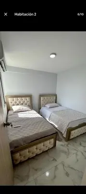 two beds sitting next to each other in a bedroom at Apartamento, Barranquilla - Miramar in Barranquilla
