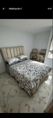 a bedroom with a bed with a floral bedspread at Apartamento, Barranquilla - Miramar in Barranquilla