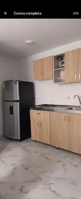 a kitchen with wooden cabinets and a stainless steel refrigerator at Apartamento, Barranquilla - Miramar in Barranquilla