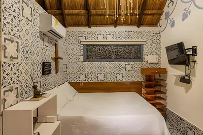 a small bedroom with a bed and a window at Tita Tati Disconnect near Cartagena in Punta Canoas
