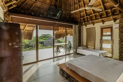 a bedroom with a bed and a large window at Tita Tati Disconnect near Cartagena in Punta Canoas