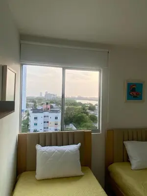 a bedroom with a window with a view of a city at Cartagena Chic Full Apto in Cartagena de Indias