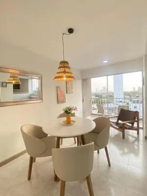 a dining room with a table and chairs with a view at Cartagena Chic Full Apto in Cartagena de Indias