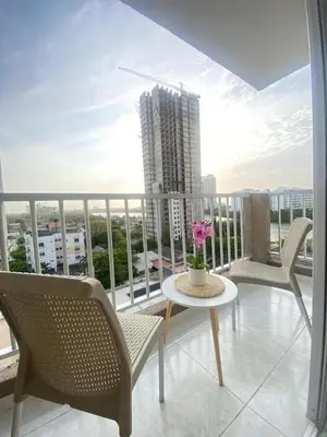 a balcony with a table and chairs and a building at Cartagena Chic Full Apto in Cartagena de Indias