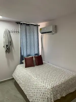 a small bed with two pillows in a room at Sky View Apartment en Barranquilla in Barranquilla
