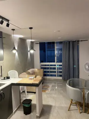 a kitchen and living room with a table and chairs at Sky View Apartment en Barranquilla in Barranquilla