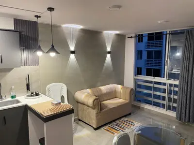 a living room with a chair and a sink at Sky View Apartment en Barranquilla in Barranquilla