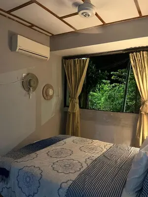 a bedroom with a bed and a window at Habitacion frente al mar en Tolú in Santiago
