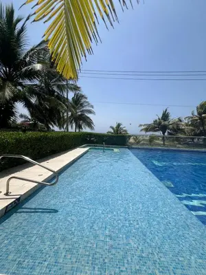 a large swimming pool with palm trees in the background at Morros Vitri directo al Mar in Cartagena de Indias