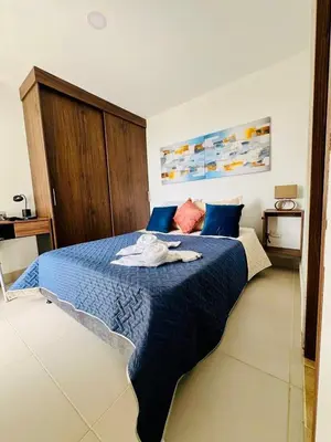 a bedroom with a blue bed with a towel on it at Villas del mar in Cartagena de Indias