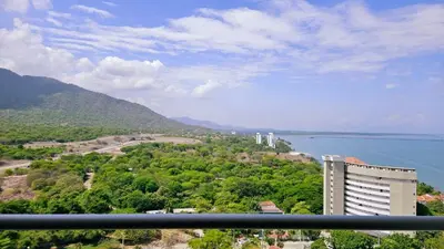 a view of a city and the water and a building at Caribbean Refuge - Beach and Pool Access 10th Floor in Santa Marta