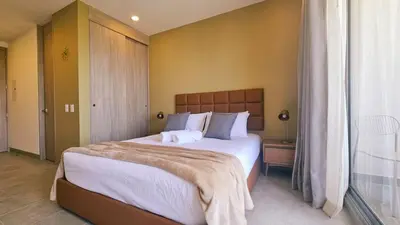 a bedroom with a large bed and a window at Caribbean Refuge - Beach and Pool Access 10th Floor in Santa Marta