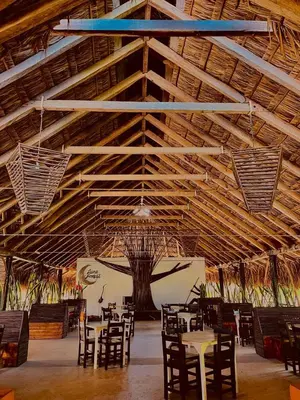 a dining room with tables and chairs in a building at Ekoparque Lunaforest in Guayepo