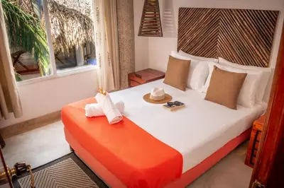 a bedroom with a bed with a hat on it at Ekoparque Lunaforest in Guayepo