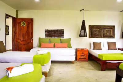 a room with two beds and a couch at Ekoparque Lunaforest in Guayepo