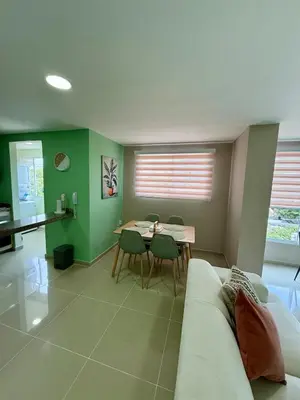 a living room with a couch and a table at Apto Acogedor Moderno y Familiar Excelente Ubicación norte Barranquilla in Barranquilla