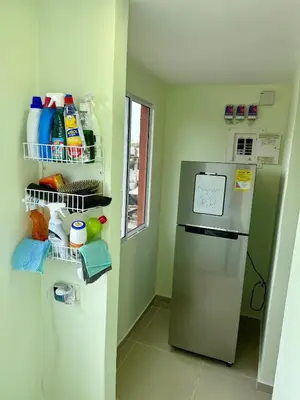 a small kitchen with a refrigerator and a window at Apto Acogedor Moderno y Familiar Excelente Ubicación norte Barranquilla in Barranquilla