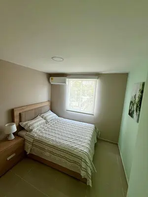 a small bedroom with a bed and a window at Apto Acogedor Moderno y Familiar Excelente Ubicación norte Barranquilla in Barranquilla