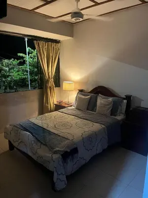 a bedroom with a large bed and a window at Habitación con baño privado y aíre acondicionado frente al mar in Santiago