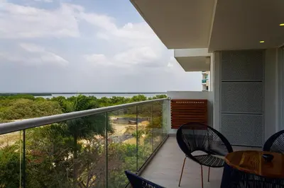 a balcony with chairs and a view of the ocean at Modern Apartment Cielo Mar Terrace-Pool-Jacuzzi Close to the beach in Cartagena de Indias