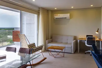 a living room with a couch and a table at Modern Apartment Cielo Mar Terrace-Pool-Jacuzzi Close to the beach in Cartagena de Indias