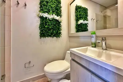 a bathroom with a toilet and a sink and a mirror at Modern Apartment Cielo Mar Terrace-Pool-Jacuzzi Close to the beach in Cartagena de Indias