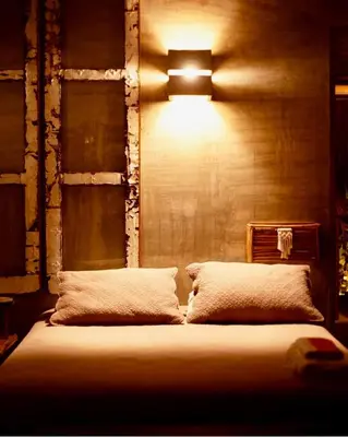 a bedroom with a bed with a light on the wall at En La Casa Del Mar in Moñitos
