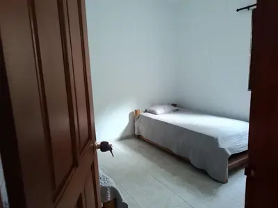 a bedroom with a bed in the corner of a room at La Trinidad in Santa Veronica