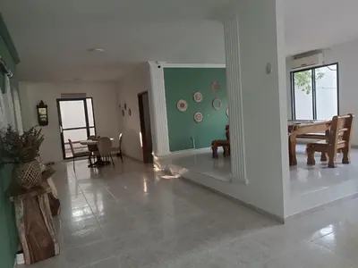 a living room with a table and a dining room at La Trinidad in Santa Veronica