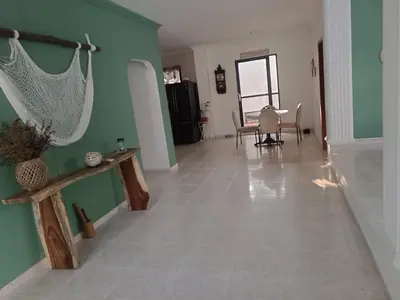 a hallway with a table and a dining room at La Trinidad in Santa Veronica