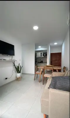 a living room with a couch and a dining room at apartamento cerca de la playa in Cartagena de Indias