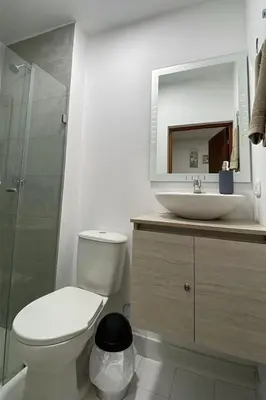 a bathroom with a toilet and a sink and a mirror at apartamento cerca de la playa in Cartagena de Indias