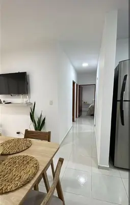 a dining room with a table and a refrigerator at apartamento cerca de la playa in Cartagena de Indias