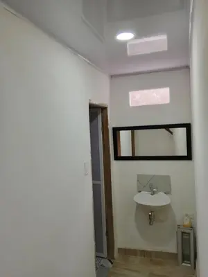 a bathroom with a sink and a mirror at Kasa Soffi in Moñitos