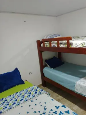 a room with two bunk beds and a bed at Kasa Soffi in Moñitos