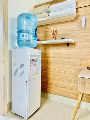 a refrigerator with a water container on top of it at Moderno apartamento en Playas del Francés