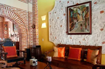 a living room with a couch and a painting on the wall at Luxury Colonial Villa Old City Cartagena Rooftop Views Private Pool in Cartagena de Indias