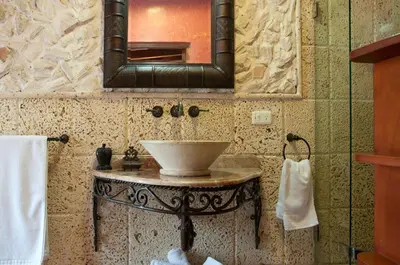 a bathroom with a sink and a mirror at Luxury Colonial Villa Old City Cartagena Rooftop Views Private Pool in Cartagena de Indias