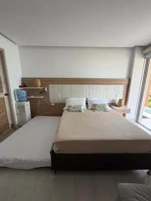 a bedroom with a large bed and a large window at Aves de Laguna Beach