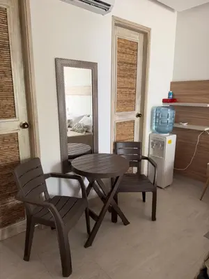a table and two chairs and a mirror in a room at Aves de Laguna Beach