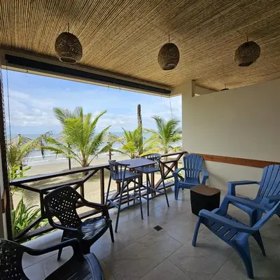 a patio with chairs and tables and a view of the beach at Aves de Laguna Beach