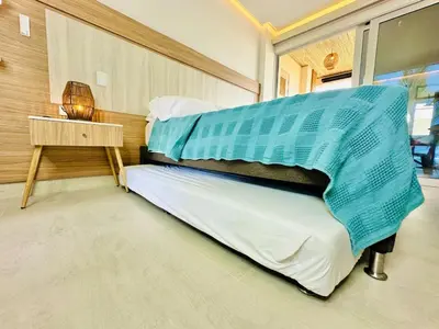 a bedroom with two beds and a table at Aves de Laguna Beach in Trementino