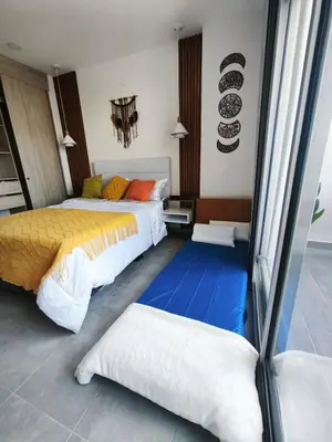 a bedroom with two beds and a blue floor at Modern suite steps from the sea in Santa Marta
