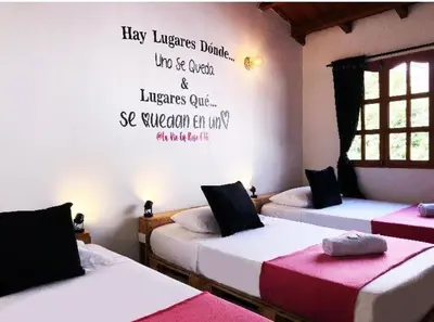 a room with two beds with writing on the wall at Confort Compartida Ctg x3 in Cartagena de Indias