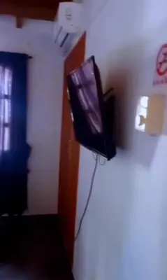 a television sitting on the corner of a room at Confort Compartida Ctg x3 in Cartagena de Indias